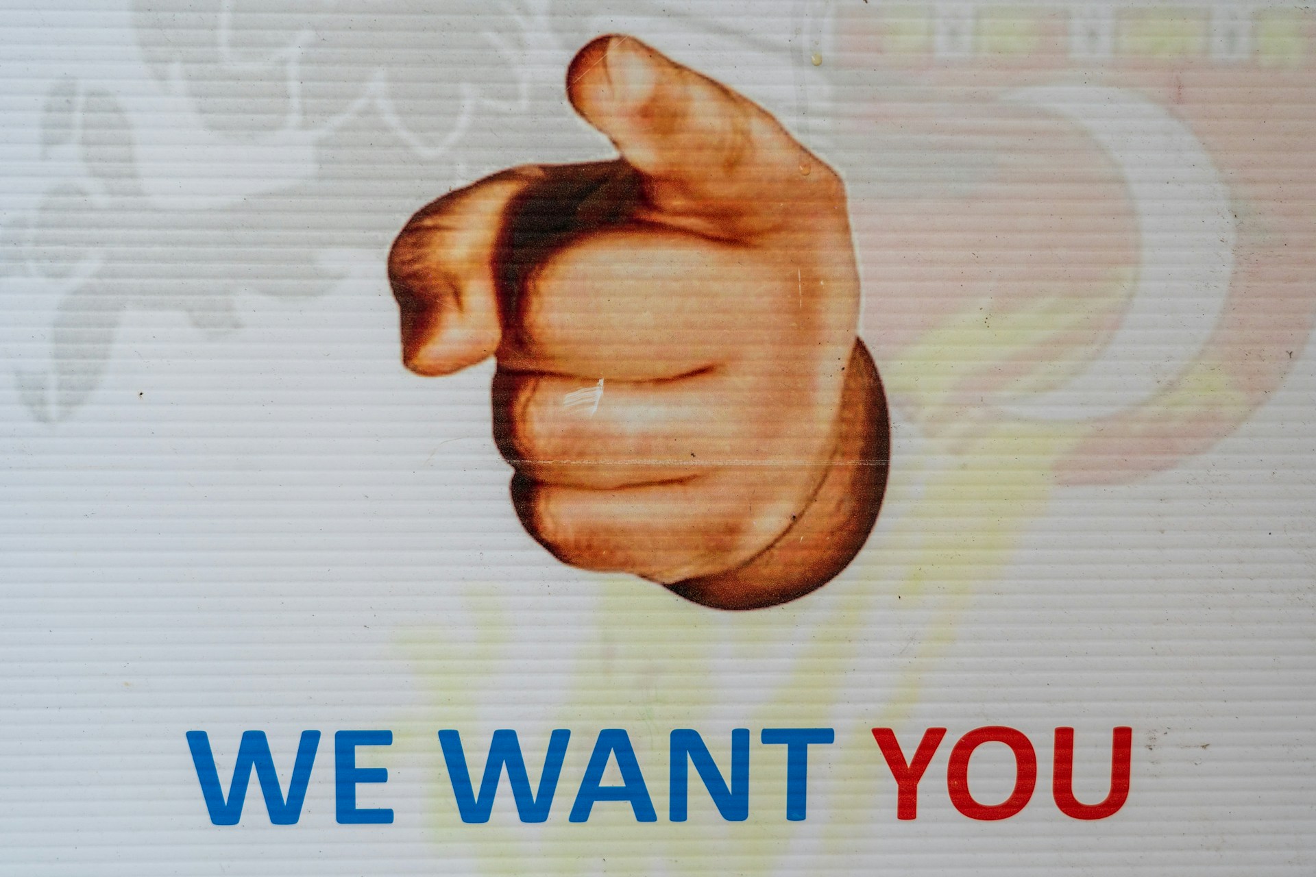 Finger pointing at the screen. Text "We want you"